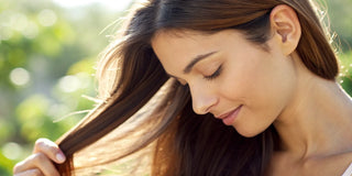 Woman with smooth, shiny hair, a result of using the best products for dry and frizzy hair.