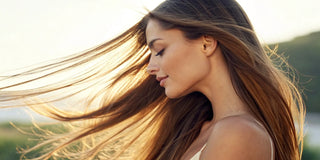 A woman with smooth, shiny hair after her Brazilian renewal hair treatment.