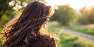 Woman with smooth, shiny hair after a keratin treatment for frizzy hair.