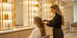 Stylist performing an express keratin blowout on a client for smooth, shiny hair.