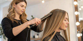 Stylist applying a salon keratin smoothing treatment for shiny, frizz-free hair.